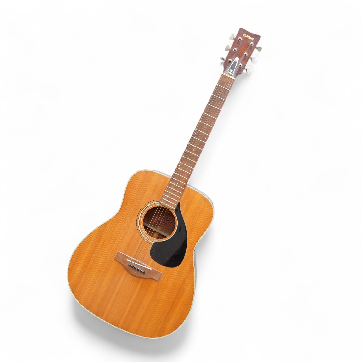 A Yamaha FG-180 acoustic steel string guitar